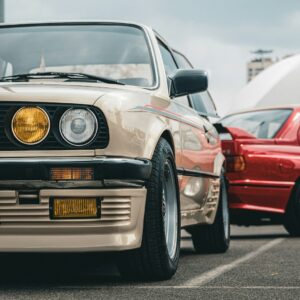 Classic BMW cars are parked outdoors.