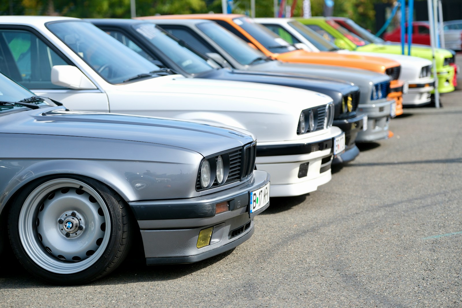 Several vintage cars are parked in a row.
