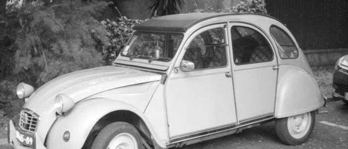 an old car is parked in a parking lot