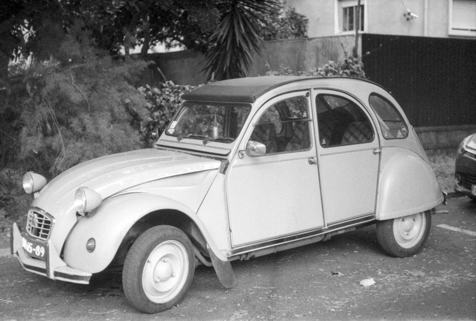 an old car is parked in a parking lot