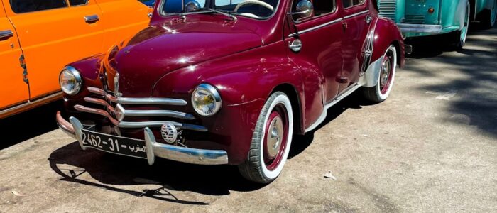 a row of old cars parked next to each other