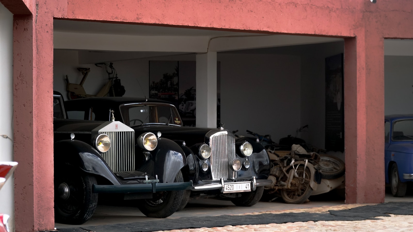A group of old cars parked in a garage