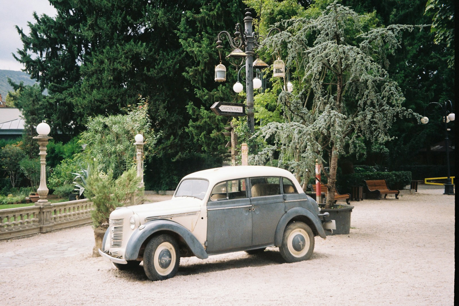 An old car is parked in a parking lot