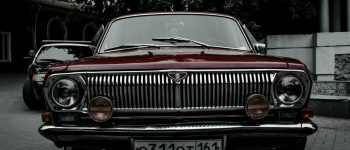 a red car parked on a brick road