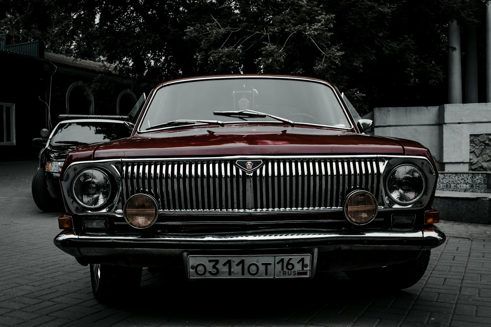 a red car parked on a brick road