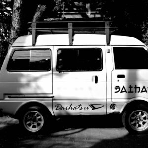 A small van parked outside on a sunny day.